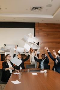 coworkers celebrating a great year in their boardroom around the table