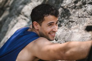 rock climber smiling because he is protected with Prudential Life Insurance